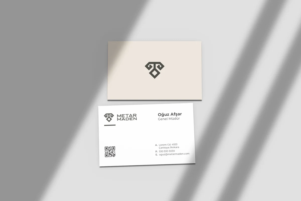 Corporate identity items arranged on a neutral surface, showing the wordmark across several applications.