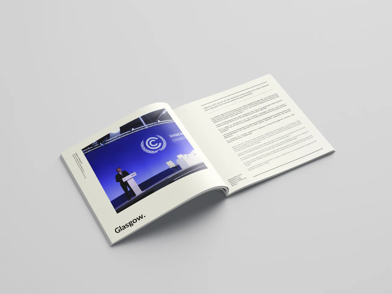 A printed prestige book lying open, showing an editorial spread with photography and a text column.