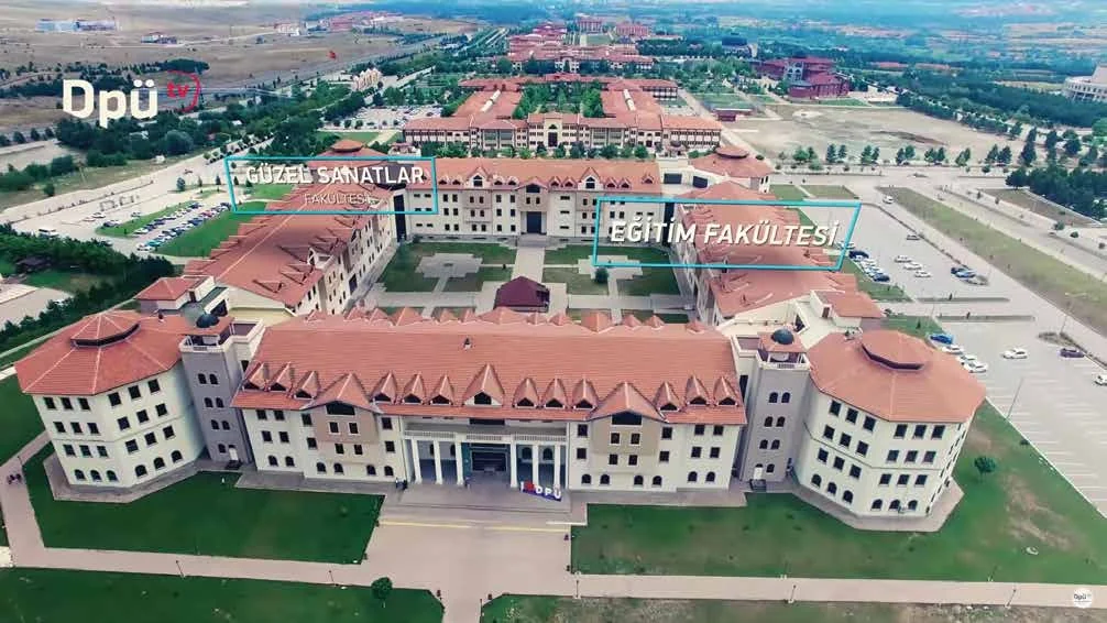 Aerial shot of campus faculty buildings with an on-screen caption.
