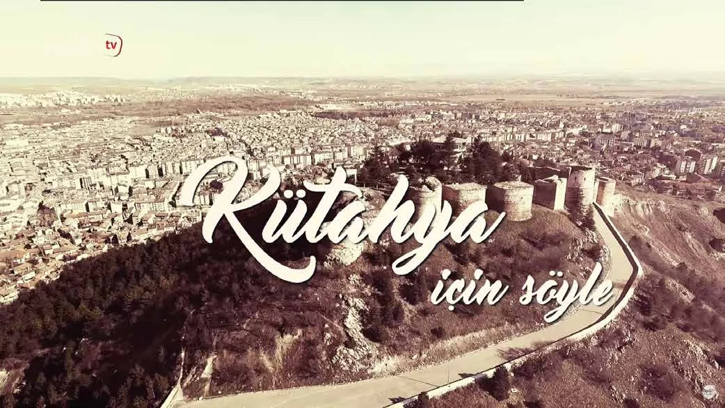 Programme title card in script lettering over an aerial view of a city.