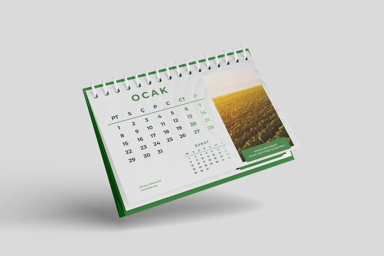 Desk calendar standing open, with an illustrated circular diagram on the left page and a month grid on the right.